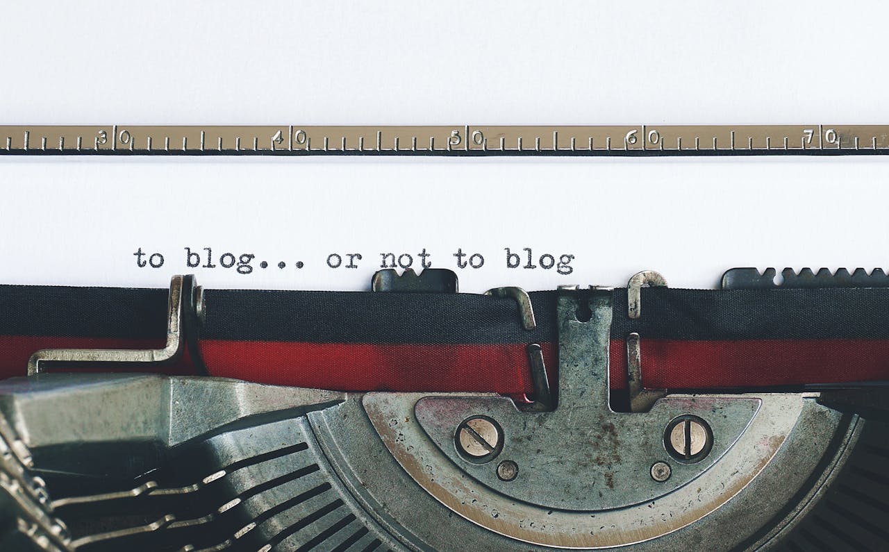 about-01 Classic typewriter with 'to blog or not to blog' typed on paper.